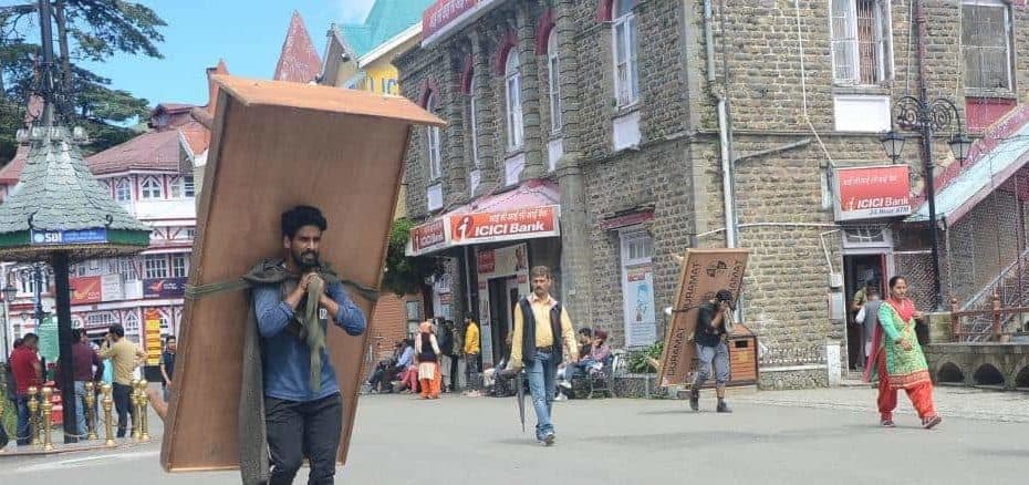 A migrant worker in Kashmir carrying goods