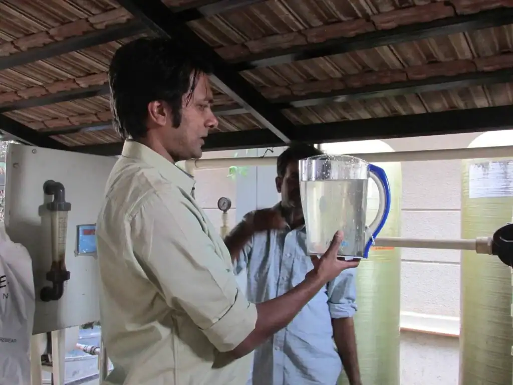 A man holding a large jug of water.