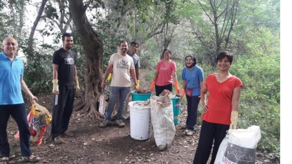 People collecting litter in a green area